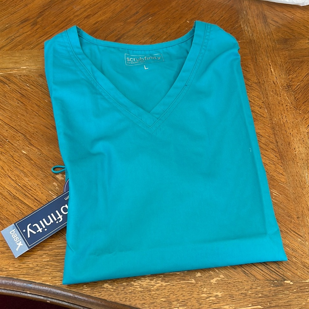 Scrub top. Teal nwt never worn wrong size for me.
